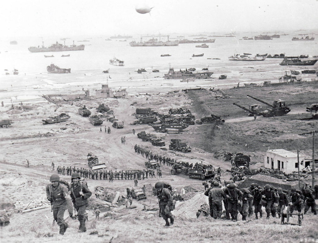 Reinforcements and artillery press inland from Omaha Beach two days after the initial invasion. Within a week of D-Day, more than 300,000 Allied troops and 2,000 tanks had arrived in France, but the beachhead remained pinched and crowded.