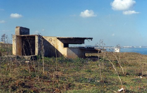Remains of French coastal bunker at Cherqui, Morocco, with Fedala in the background. (Chapters 2,3)