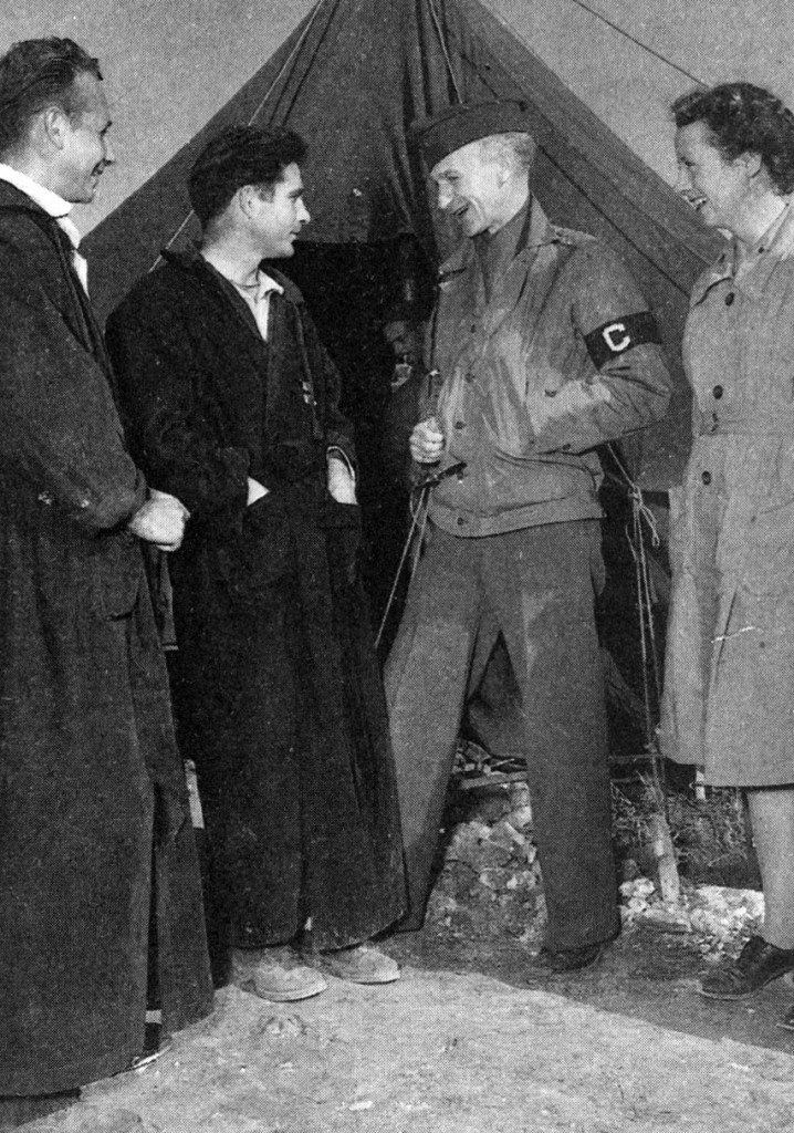 Correspondent Ernie Pyle, slender as a thread at one hundred pounds and given to drink and melancholy, arrived in North Africa with a typewriter to educate America about the war. Here he is seen with wounded soldiers at a hospital near St. Cloud, Algeria, in early December 1942.