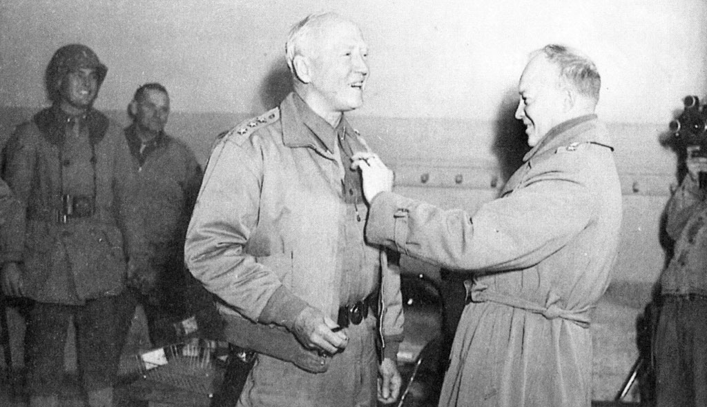 On March 16, 1943, on the eve of the II Corps attack on Gafsa, Eisenhower pins a third star on buoyant Patton to mark his promotion to lieutenant general.
