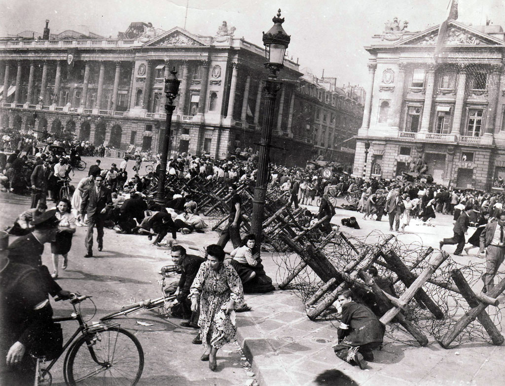 Sniper fire sends French citizens sprawling or fleeing in the Place de la Concorde on August 26, 1944.