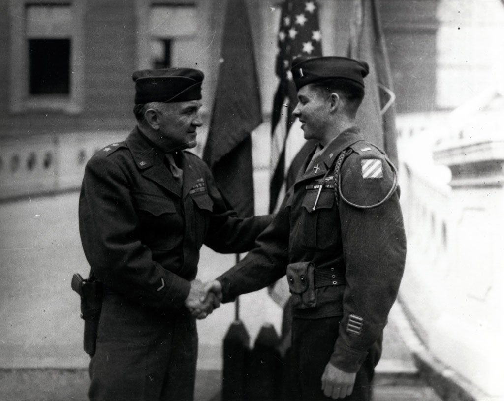Lieutenant Audie Murphy, right, is congratulated by Major General John W. "Iron Mike" O'Daniel