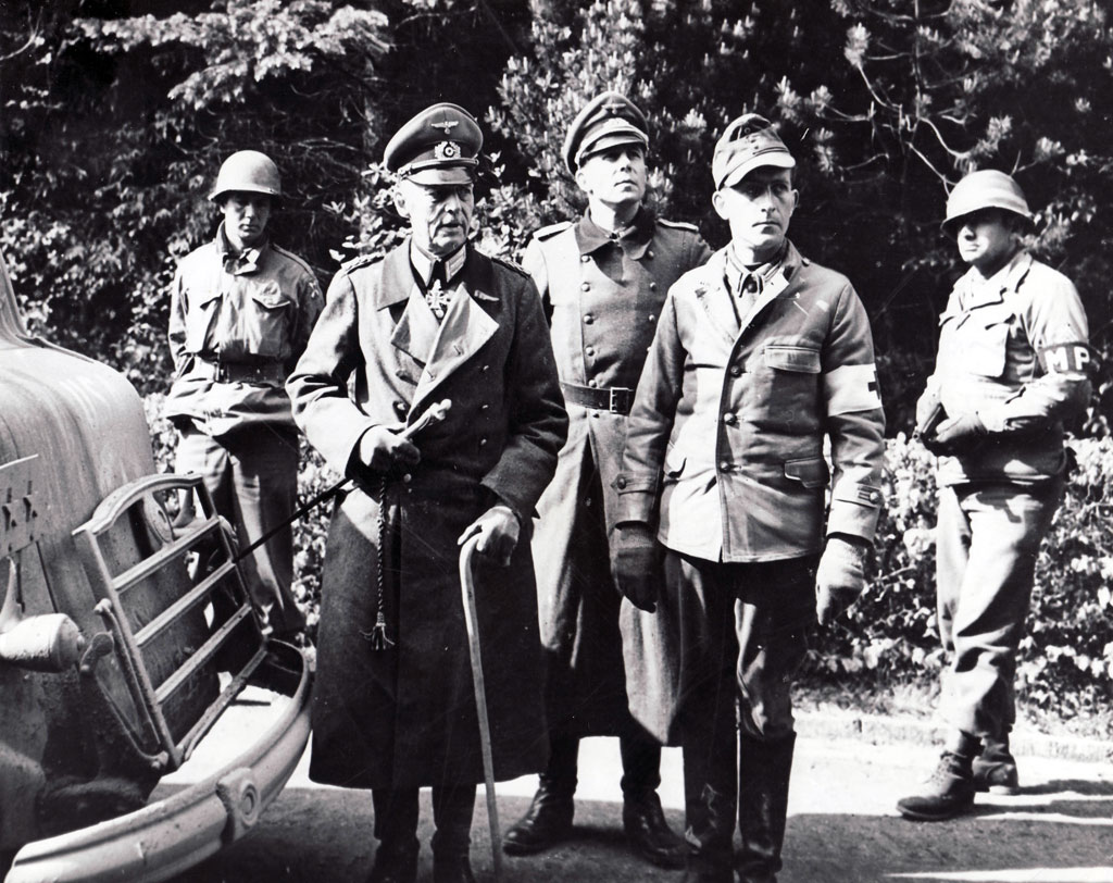 Field Marshal Gerd von Rundstedt following his capture by American troops south of Munich on May 2. The former OB West commander is accompanied by a medic wearing a brassard, and his son, a German lieutenant.
