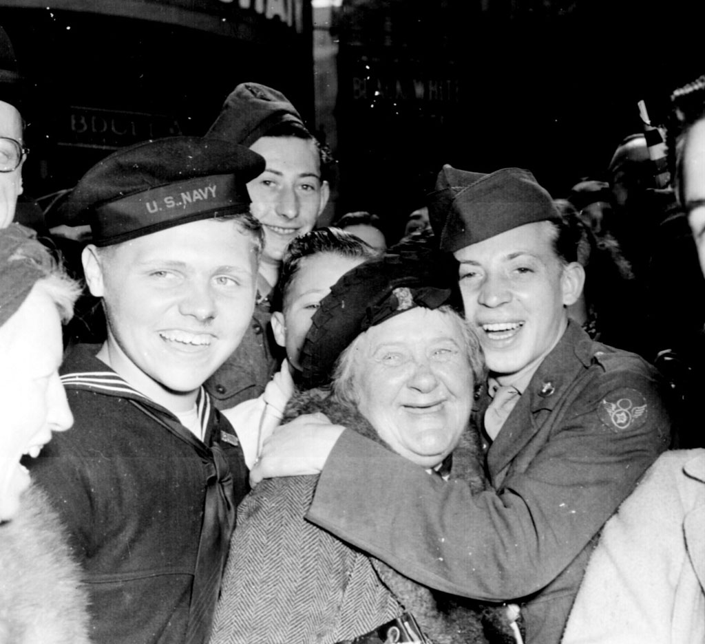 On the night of May 7, hours before the official end of the war in Europe, jubilant Americans celebrate with the British at Piccadilly in central London.